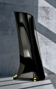 Enceinte Adamantis noir avec des pointes dorées vue de côté sur un fond de béton